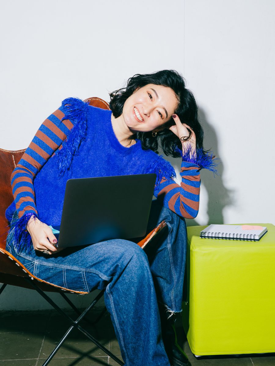 Woman smiling while working on her computer